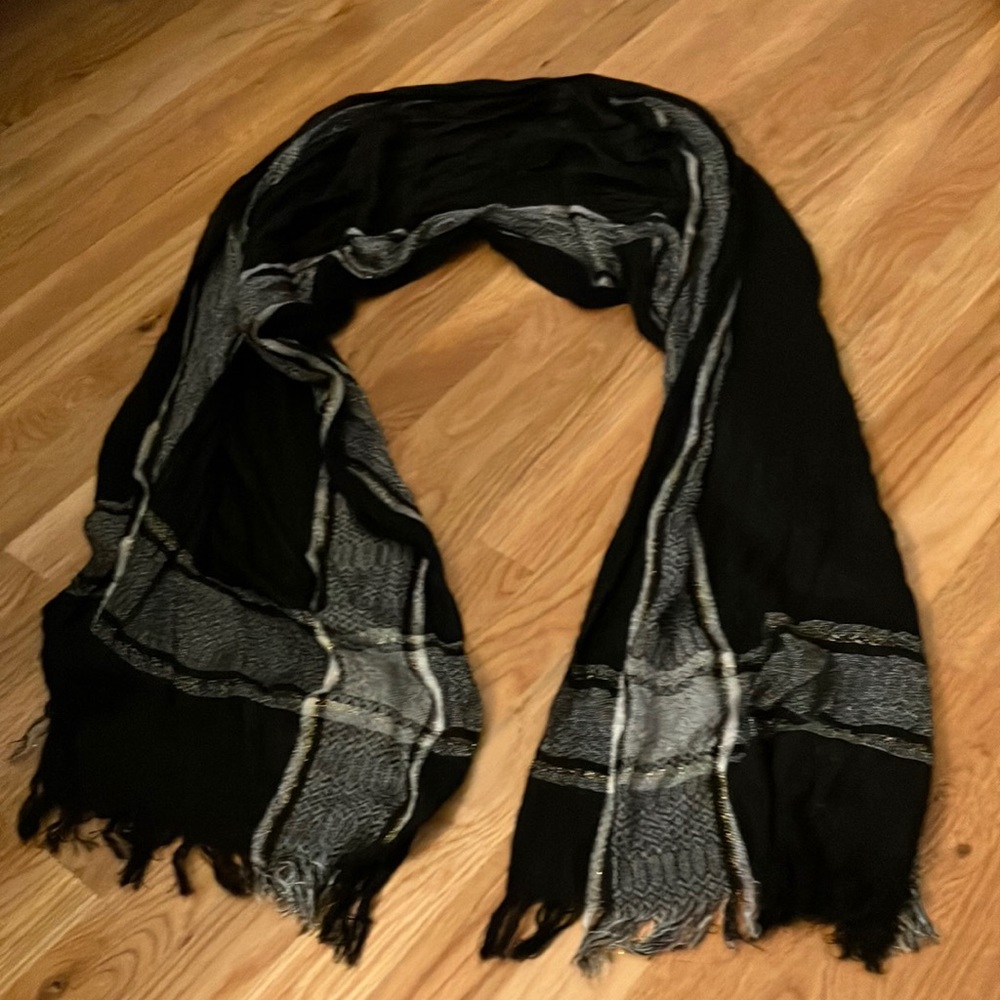 Delicate shall with a chic plaid design and a touch of gold with fringe